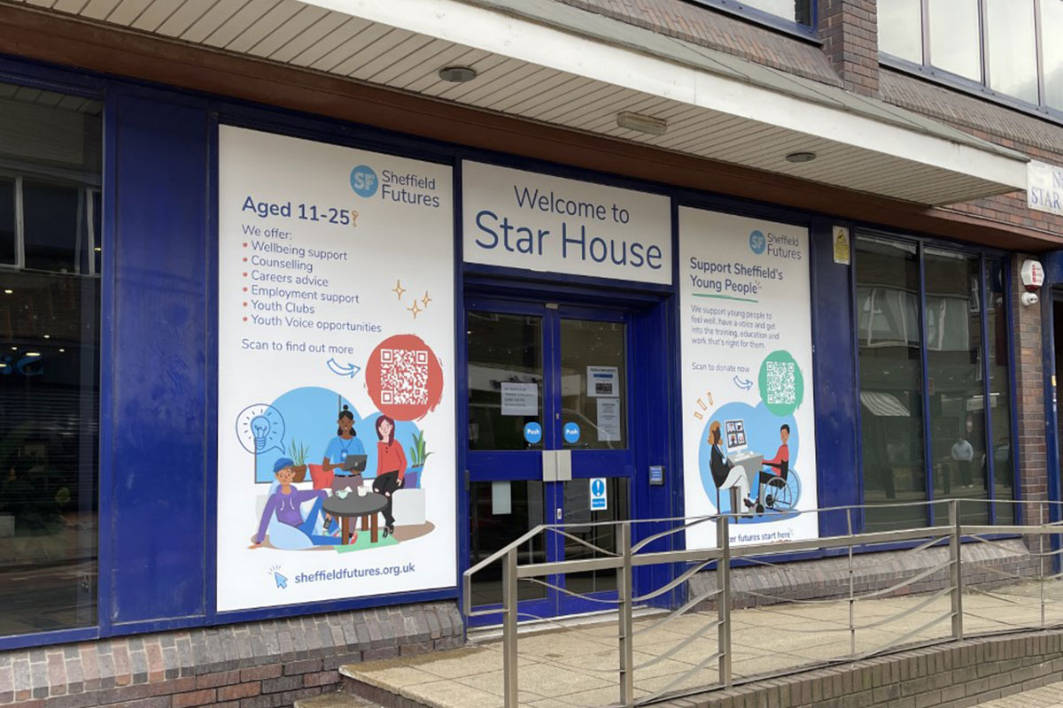 photograph of the front entrance to Star House, featuring the front door and exterior signage which welcomes visitors to the building