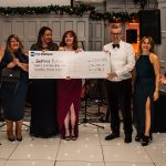 A photograph captures the moment the cheque was handed over. In this image, representatives from HE Barnes and Sheffield Futures are standing on the dancefloor smiling at the camera, holding the giant cheque.