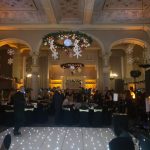 The infamous light up dancefloor in action, underneath twinkling festive wreaths and snowflake decor